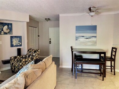 Entryway with closet and living and dining area.