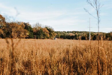 View of wooded area featuring a rural view