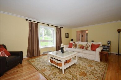 Living Room with beautiful hardwood floors, crown 