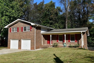 Split level home with covered porch, a garage, and