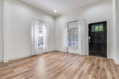 Entryway featuring light wood-style flooring and recessed lighting