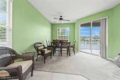 Sunroom with a water view, ceiling fan, and vaulte