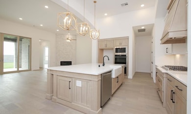 Kitchen featuring a chandelier, a large fireplace