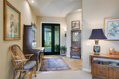 Foyer with french doors, baseboards, light tile p