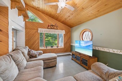 Tiled living room featuring a wealth of natural li