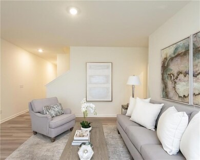 Living area with wood finished floors and recessed lighting