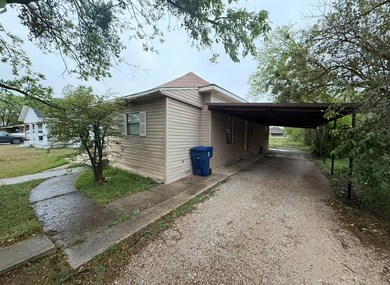 View of side of home featuring driveway and an att