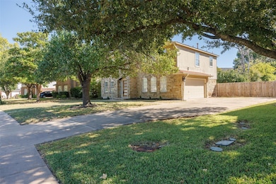 View of front of property featuring driveway, a garage, and brick siding