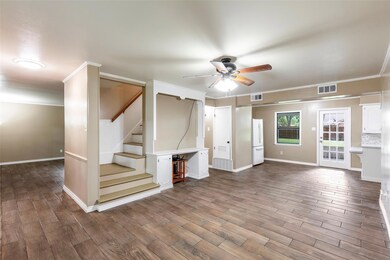 Unfurnished living room featuring crown molding, ceiling fan, and hardwood / wood-style floors