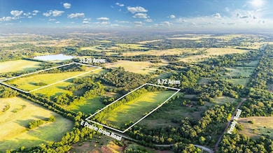 Aerial view featuring a rural view and a water view