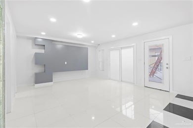 Unfurnished room with light tile patterned floors