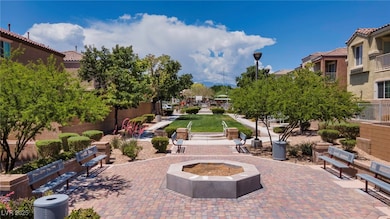 View of community with a patio and an outdoor fire