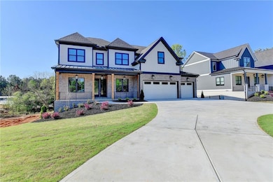 Modern farmhouse with a standing seam roof, covere