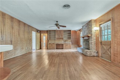 Unfurnished living room with a brick fireplace, li
