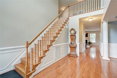 2-story foyer with new tile flooring leading to hw