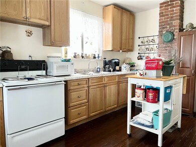 Kitchen offers nice cabinetry and hardwood floorin