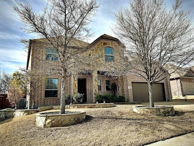 View of front facade featuring brick siding, an at