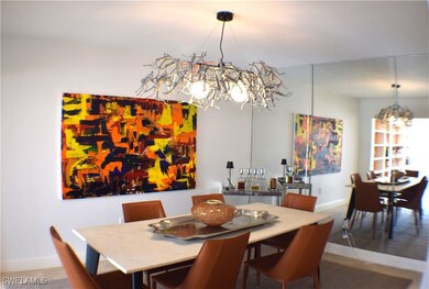 Dining area featuring an artistic chandelier.