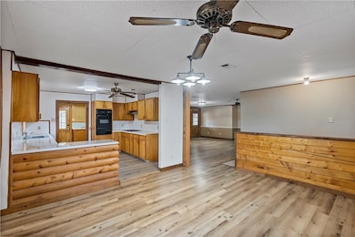 Kitchen with dobule oven black, a ceiling fan, bro