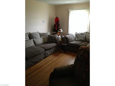 Living room with hardwood flooring neutral decor