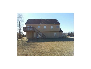 Back of Home with a nice deck and a small patio.