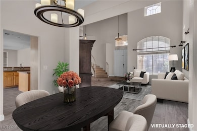 Living room with a high ceiling, wood finished flo
