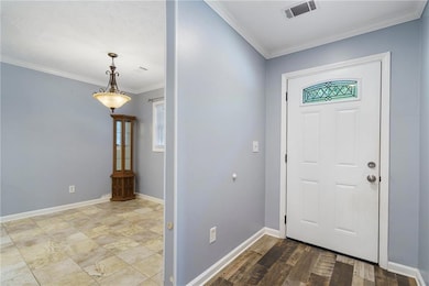 Entrance foyer featuring crown molding