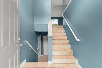 Stairs with baseboards and tile patterned flooring