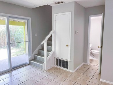 Staircase with tile patterned floors and baseboar