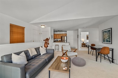 Living room with light colored carpet, a baseboard