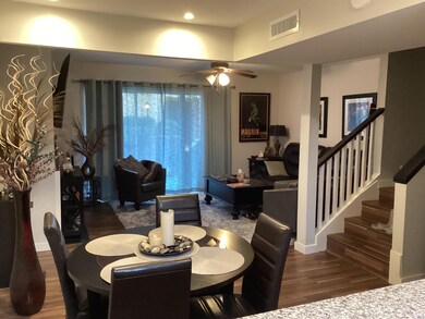 Dining area with visible vents, ceiling fan, wood 