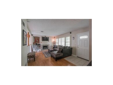 Large living room with fireplace & tile entry.