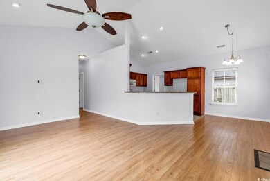 Unfurnished living room featuring a chandelier, ceiling fan, light wood-type flooring, recessed lighting, and high vaulted ceiling