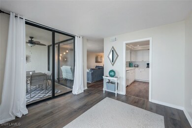 Bedroom with dark hardwood / wood-style flooring, ensuite bath, and ceiling fan