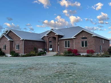 View of front facade with brick siding and a front yard