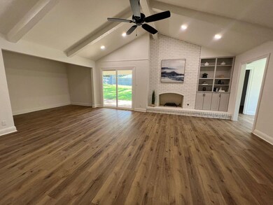 Unfurnished living room featuring lofted ceiling w