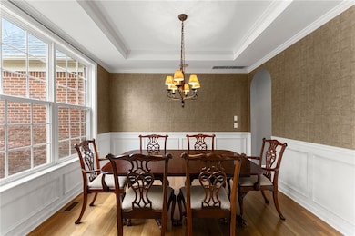 Dining area featuring a notable chandelier, wallpa