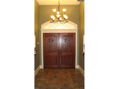Foyer with inlaid tile floor and two art niches