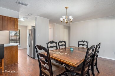 Dining space with dark wood-type flooring, crown m