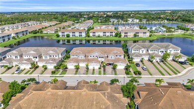 Aerial perspective of suburban area featuring a nearby body of water