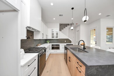 The kitchen features upgraded black stainless stee