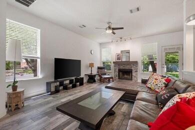 Living room with a ceiling fan, wood finished flo