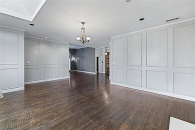 Spare room with dark wood-type flooring and an inv