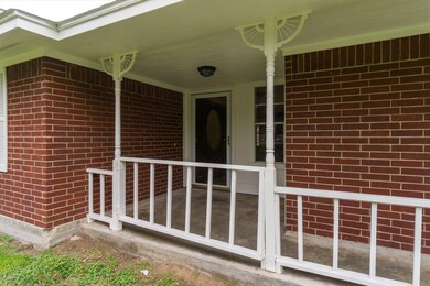 Covered front porch to sit and enjoy your 5 acre l