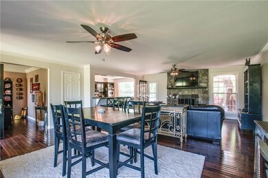 Newly remodeled Dining & Living Room with new hardwood, paint & remote ceiling fans.