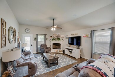 Living room featuring lofted ceiling, ceiling fan,