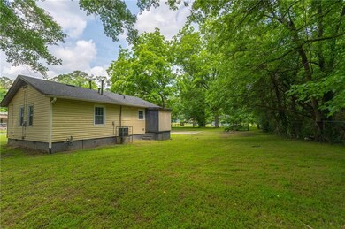 View of grassy yard featuring central AC unit