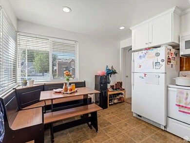 Kitchen with white appliances, recessed lighting, and white cabinetry