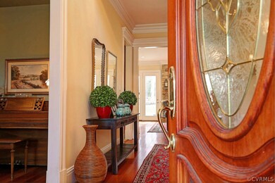 A beautiful mahogany entry leads to the stunning t