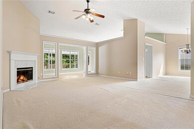 Unfurnished living room with visible vents, a fire